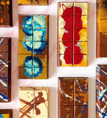 Close-up of chocolate bar showing pistachio, tahini, and kataifi layers